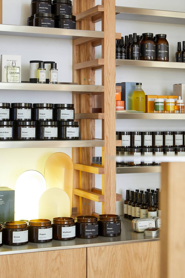 Attractive candles, fragrances, and personal care items displayed on wooden shelves